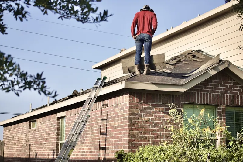 Professional roofer working on a residential roof in Ruidoso